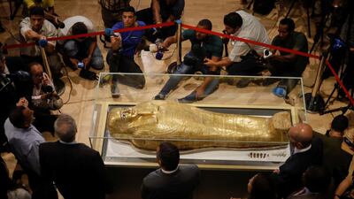 The coffin is surrounded by members of the media. Reuters