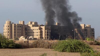 Columns of smoke rise from the Al-Qasr Hotel. Stringer / EPA
