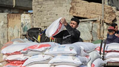 Palestinians collect food aid at a distribution centre run by UNRWA in Gaza City. The agency has faced funding problems for many years. AFP