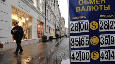 A man counts his money as he walks down a street in an up-market area of Moscow, which has been hit by a wave of street robberies.