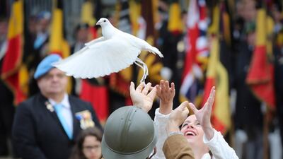 People release a dove during a ceremony at the tomb of the unknown soldier at Congres Column, in Brussels, Belgium. EPA