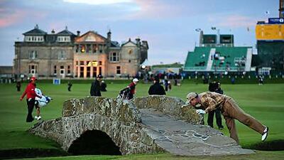 Tom Watson kisses the Swilken Bridge as he said an emotional farewell to the galleries at St Andrews on Friday.