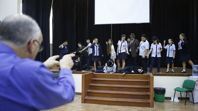 Roger Shipton directs Al Ain English Speaking School pupils during a rehearsal of Bugsy Malone. Ravindranath K / The National