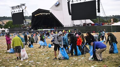 Volunteers clean up by the Pyramid Stage at Worthy Farm in Somerset, after the Glastonbury Festival in Britain. Reuters