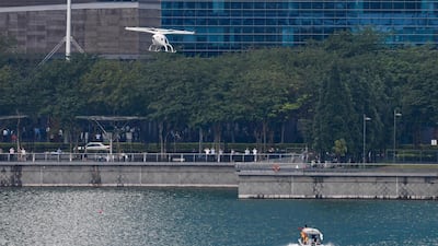 A Volocopter unmanned air taxi transport flies over Marina Bay during test flight with a safety pilot at the 26th Intelligent Transport Systems World Congress (ITSWC) in Singapore. AFP