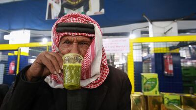 A Jordanian man tastes freshly-pressed olive oil at an automatic press in Mahis, west of the capital Amman. AFP