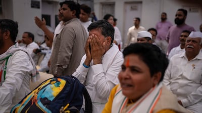 Congress supporters watch the live broadcast of vote counting at the party's headquarters in New Delhi. AP