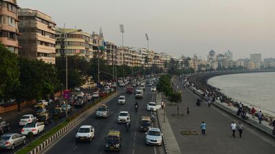 Buildings line the seafront in Mumbai. Non-resident Indians are investing less in homes in India. Punit Paranjpe / AFP