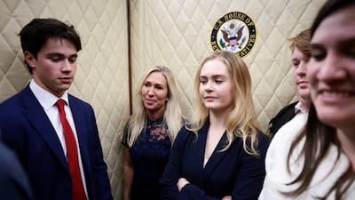 US Representative Marjorie Taylor Greene, centre, gets into a lift as she heads to her final vote, surrounded by staff, at the US Capitol in Washington. Reuters