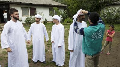 Volunteers with Etihad Airways’ Colour Their Lives initiative distribute care packages at the centre for asylum seekers in Krnja, Serbia. Christopher Pike / The National