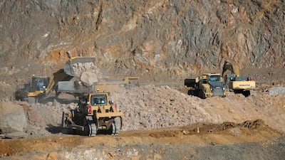 Wheel loaders fill trucks with ore at the MP Materials rare-earth mine in Mountain Pass, California. Reuters