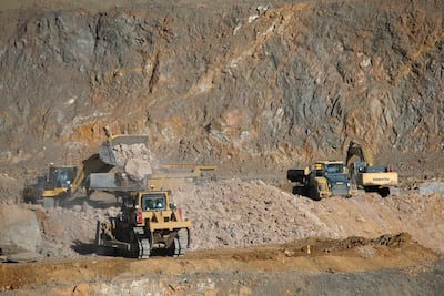 Wheel loaders fill trucks with ore at the MP Materials rare-earth mine in Mountain Pass, California. Reuters