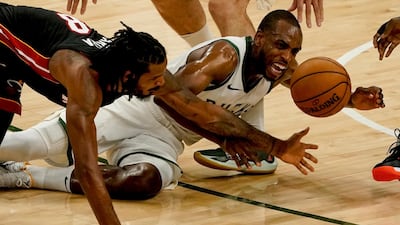 Miami Heat's Trevor Ariza and Milwaukee Bucks' Khris Middleton go after a loose ball. AP