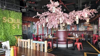 Soul Street at the Five Jumeirah Village in JVC features colourful interiors, complete with a cherry blossom tree. Photo: Antonie Robertson/The National
