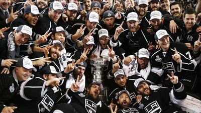 Los Angeles Kings pose with the Stanley Cup after defeating the New York Rangers in Game 5 of their NHL Stanley Cup Finals in Los Angeles. Lucy Nicholson / Reuters