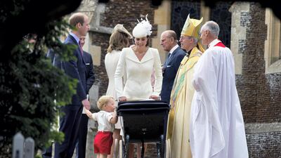 Catherine, Duchess of Cambridge looks on as Prince George looks into his sister Princess Charlotte's pram during her Christening in July 2015 in King's Lynn. Getty Images