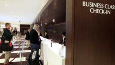 Passengers at Etihad's business class check-in desk at Abu Dhabi International Airport.