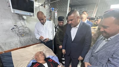 Iraq's Interior Minister Lt Gen Abdul Amir Al Shammari visits Civil Defence chief Maj Gen Kadhim Bohan, a survivor of the building collapse, at a hospital in Baghdad. Photo: Iraq Civil Defence