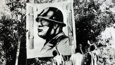 Abyssinians salute a picture of Benito Mussolini after Italy invaded Ethiopia in 1935. Ian Campbell’s The Addis Ababa Massacre gives an incisive account of the 1937 slaughter of 30,000 people. Popperfoto / Getty Images.