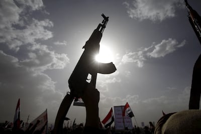 A Houthi supporter holds up a weapon during a rally against a year of Saudi-led air strikes, in Yemen's capital Sanaa in 2016. Reuters
