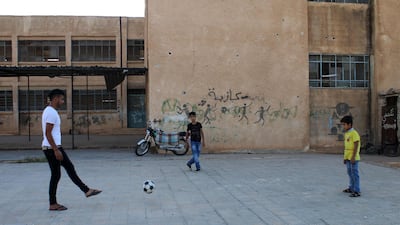 Moawiya Sayasina plays football with other children in a rebel-held neighbourhood in the southern Syrian city of Daraa. Mohamad Abazeed / AFP