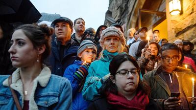 People stand on the stairs of Sixth Presbyterian Church as the crowd spills up the hill and down the street for a vigil blocks from where a shooting occured at the Tree of Life synagogue. AP Photo