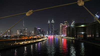 Dubai Canal'a waterfall is illuminated. EPA