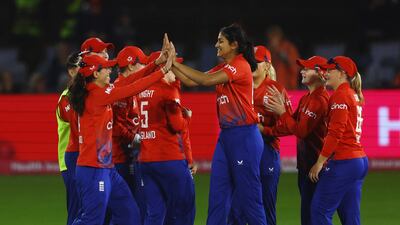England teammates celebrate with Mahika Gaur. Reuters