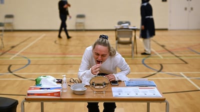 A teacher takes a Covid-19 lateral flow test in the sports hall of Park Lane Academy in Halifax, northwest England, as the school prepares to reopen. AFP