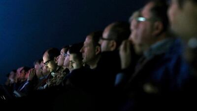 People listen to a speech during the Mobile World Congress in Barcelona. Alberto Estevez / EPA