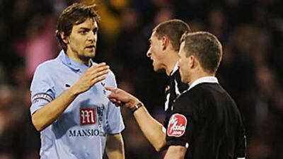 The Tottenham captain Jonathan Woodgate has a word with the under-fire referee Steve Tanner during the match at the Hawthorns.