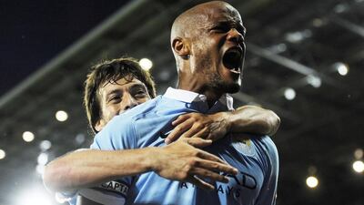 Vincent Kompany, right, celebrates with teammate David Silva. Hannah McKay / EPA / August 11, 2015