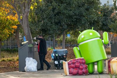 A worker cleans a trash receptacle on the Google campus in Mountain View, California, US, December 16. Bloomberg