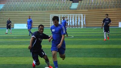 Abu Dhabi Media, in blue, who finished third in the Abu Dhabi Government Ramadan Football Championship last season, began their campaign this year with a 3-1 win over Tourism Development and Investment Company on Sunday. Courtesy Abu Dhabi Sports Council