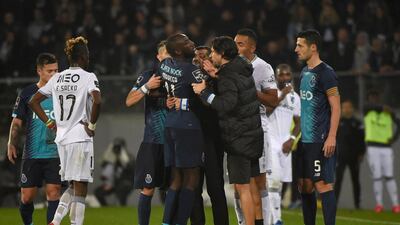 FC Porto's Malian forward Moussa Marega attempts to leave the pitch after hearing racists chants as his coach Sergio Conceicao tries to stop him. AFP