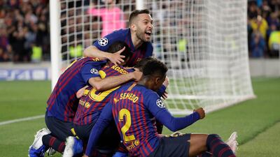 Barcelona players celebrate after Lionel Messi scored his side's third goal. Emilio Morenatti / AP Photo