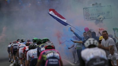 The peloton rides through smoke from fans on the side of the road during Stage 8 of the Tour de France cycling race over 184km between Pau and Bagneres-de-Luchon, France, 09 July 2016. Yoan Valat / EPA