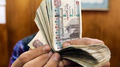 An employee counts Egyptian pounds at a foreign exchange office in central Cairo. Reuters