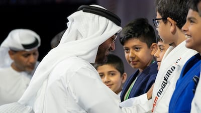 Sheikh Mohammed bin Zayed Al Nahyan Crown Prince of Abu Dhabi Deputy Supreme Commander of the UAE Armed Forces (L), awards a medal to a participant during the Abu Dhabi Jiu-Jitsu Festival. Mohamed Al Hammadi / Crown Prince Court - Abu Dhabi