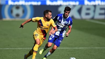 Barcelona defender Jordi Alba runs with the ball under pressure from Manu Garcia of Alaves. Getty Images