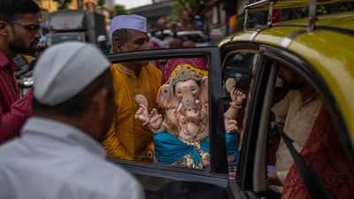 Devotees carry a Ganesha idol in Mumbai. AP Photo
