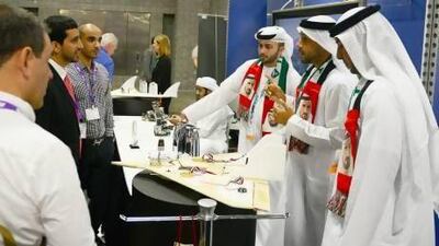 Some Innovation Challenge participants from the UAE speak with conference attendees in Washington. Courtesy Northrop Grumman Corp