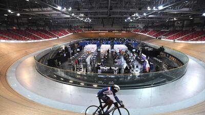 A cycling French team member trains as patients are being vaccinated with Moderna Covid-19 vaccine in the national velodrome, southwest of Paris. AFP