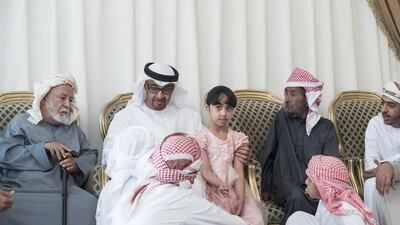 Sheikh Mohammed bin Zayed, Crown Prince of Abu Dhabi and Deputy Supreme Commander of the Armed Forces, offers condolences to children and family of Ahmed Al Mazrouei who was killed in the terrorist attack on the Kandahar Governor’s headquarters in Afghanistan. Seen with Rashid Saeed Al Mazrouei, father of the victim (2nd R). Ryan Carter / Crown Prince Court - Abu Dhabi