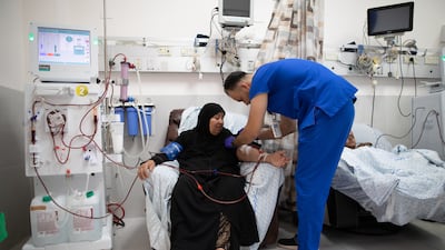 A medic prepares a patient from Gaza to receive dialysis treatment at Al Makassed Hospital in East Jerusalem. The UAE has signed a $25 million agreement to support the hospital, which provides health services to the Palestinian community. Corinna Kern for The National