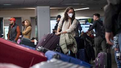 A traveller retrieves luggage at San Francisco International Airport in California on Tuesday. Bloomberg