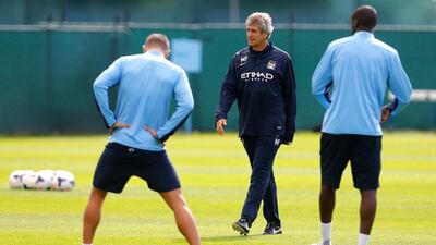 Manchester City manager Manuel Pellegrini, centre, finds his methods easy to coach because he has never changed them. Paul Thomas/Getty Images