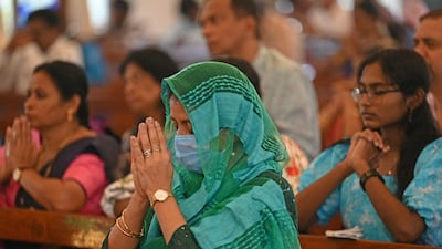 Christian devotees pray at a Christmas Mass in St. Patricks church in Chennai. AFP