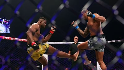 Francis Ngannou attempts a leg kick on Renan Ferreira during their heavyweight superfight title bout. Chris Whiteoak / The National