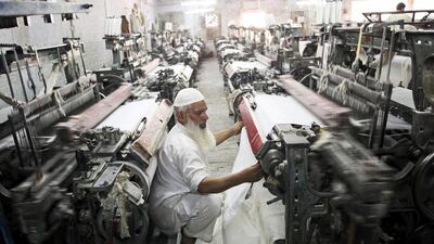 A worker inspects cotton cloth on a loom in a textile factory in the district of Faisalabad, Punjab, Pakistan. Textile and leather products, ethanol and plastics are the key sectors that will benefit from Pakistan winning key EU tariff status. Asad Zaidi / Bloomberg